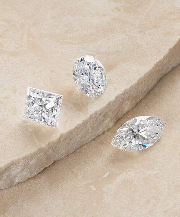 certified GIA loose diamonds in multiple cuts on stone background