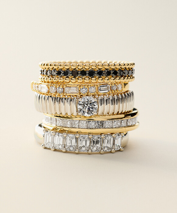 stacked wedding rings and diamond bands in gold and platinum